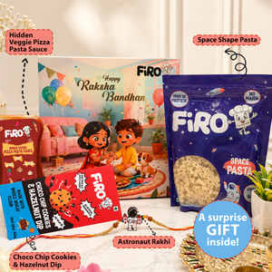 A Raksha Bandhan gift set featuring Firo branded pasta and dip products, including a blue space-shaped pasta bag, a red chocolate chip cookie and hazelnut dip packet, and a hidden veggie pizza pasta sauce packet, arranged with a personalized Rakhi and a colorful birthday card backdrop.